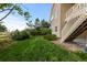 Manicured backyard featuring a grassy area, stairs for patio access, landscaping, and scenic views at 17223 W 84Th Dr, Arvada, CO 80007
