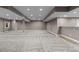 Finished basement with neutral carpeting, recessed lighting, and a wet bar area at 17223 W 84Th Dr, Arvada, CO 80007
