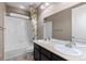Bright bathroom featuring double sinks, a bathtub, and tiled floors at 17223 W 84Th Dr, Arvada, CO 80007