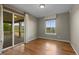 Bedroom with hardwood floors, large window, and a sliding glass door to the deck at 17223 W 84Th Dr, Arvada, CO 80007