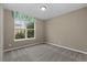 Cozy bedroom featuring neutral carpet and a large window at 17223 W 84Th Dr, Arvada, CO 80007