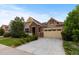 Charming two-story home featuring a well-manicured lawn, brick accents, and an attached two-car garage at 17223 W 84Th Dr, Arvada, CO 80007