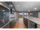 Modern kitchen featuring stainless steel appliances, granite countertops, and hardwood floors at 17223 W 84Th Dr, Arvada, CO 80007