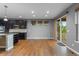 Open kitchen area with dark wood cabinets, an island with a wine rack, and a sliding glass door at 17223 W 84Th Dr, Arvada, CO 80007
