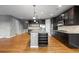 Bright kitchen with a center island, dark cabinetry, granite countertops and stainless steel appliances at 17223 W 84Th Dr, Arvada, CO 80007