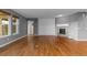 Bright, open living room with hardwood floors, a fireplace and access to other rooms through arched doorways at 17223 W 84Th Dr, Arvada, CO 80007