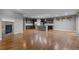 Open living space connecting the kitchen with fireplace, hardwood floors, and modern finishes at 17223 W 84Th Dr, Arvada, CO 80007