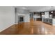 Open living room with a fireplace, hardwood flooring, and direct access to the kitchen area at 17223 W 84Th Dr, Arvada, CO 80007