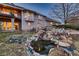 Lush backyard featuring a charming pond and rock garden with decorative accents at 7769 W 70Th Dr, Arvada, CO 80004