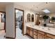 Bathroom with a large vanity, dual sinks, and a doorway to a walk-in closet at 7769 W 70Th Dr, Arvada, CO 80004