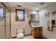 Bright bathroom with a glass-enclosed shower, single sink, and small window for natural light at 7769 W 70Th Dr, Arvada, CO 80004