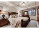 Comfortable bedroom featuring a decorative, dark wood frame bed and large window with a view at 7769 W 70Th Dr, Arvada, CO 80004
