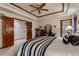 Primary bedroom featuring a tray ceiling with a ceiling fan and ample natural light at 7769 W 70Th Dr, Arvada, CO 80004