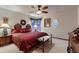 Bedroom with a decorative bed frame, ceiling fan and a window with a view to the outside at 7769 W 70Th Dr, Arvada, CO 80004