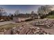Expansive home showcasing brick and stone details, plus a mature landscape and walkway to the front door at 7769 W 70Th Dr, Arvada, CO 80004