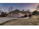 Charming single-Gathering home featuring a brick facade, three-car garage, and beautifully landscaped front yard at 7769 W 70Th Dr, Arvada, CO 80004