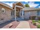 Charming brick home with covered entry and manicured landscaping offers great curb appeal at 7769 W 70Th Dr, Arvada, CO 80004