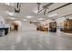 Large three car garage with epoxy floor and lots of tool storage at 7769 W 70Th Dr, Arvada, CO 80004