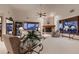 Bright living room featuring a brick fireplace, a vaulted ceiling, generous natural light, and elegant decor at 7769 W 70Th Dr, Arvada, CO 80004