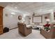 Basement living room with plush seating, entertainment center, and a projector screen at 7769 W 70Th Dr, Arvada, CO 80004