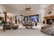 Inviting living room with a brick fireplace, large windows, plush seating, and soft, neutral carpeting at 7769 W 70Th Dr, Arvada, CO 80004