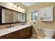 Bathroom with double vanity, granite countertops, and enclosed shower with bathtub at 12 Long Spur, Littleton, CO 80127