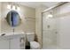 Modern bathroom with glass-enclosed shower, sleek vanity, and updated fixtures at 12 Long Spur, Littleton, CO 80127