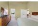 Bright bedroom with vaulted ceilings, ensuite bath, and access to the staircase at 12 Long Spur, Littleton, CO 80127