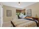 Bedroom with large window, desk, and neutral color scheme at 12 Long Spur, Littleton, CO 80127