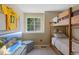 bedroom featuring a bunk bed, window, television, and sports memorabilia at 12 Long Spur, Littleton, CO 80127