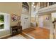 Elegant foyer with soaring ceilings, hardwood floors, and abundant natural light, creating a grand entrance at 12 Long Spur, Littleton, CO 80127