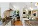 Spacious kitchen featuring a large island, countertops, and windows, with a living space in the background at 12 Long Spur, Littleton, CO 80127