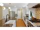Modern kitchen with stainless steel appliances, white cabinetry, granite countertops, and an island at 12 Long Spur, Littleton, CO 80127