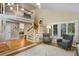 Bright living room with soaring ceilings, hardwood floors, large windows, and a cozy seating arrangement at 12 Long Spur, Littleton, CO 80127