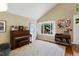 Inviting living room featuring hardwood floors, natural light, a piano, and comfortable seating for a cozy ambiance at 12 Long Spur, Littleton, CO 80127
