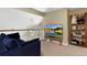 Loft with a view, a comfortable blue couch, entertainment center, and bookshelves featuring a variety of board games at 12 Long Spur, Littleton, CO 80127