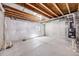 Unfinished basement with concrete floors, open ceiling, and visible pipes, ready for customization at 1640 Winona Ct, Denver, CO 80204