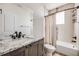 Bathroom with a single vanity, granite countertops, a combination tub and shower with decorative tile at 1640 Winona Ct, Denver, CO 80204