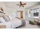 Bright bedroom featuring a ceiling fan, large window, and ensuite bathroom with barn door entrance at 1640 Winona Ct, Denver, CO 80204