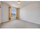 An empty bedroom with neutral carpeting, a bright window and yellow curtains, ready to personalize at 1640 Winona Ct, Denver, CO 80204