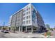 Exterior view of a modern apartment building featuring unique architectural details and street-level retail space at 1640 Winona Ct, Denver, CO 80204