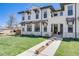 Charming home exterior featuring a lush green lawn, stone accents, and a welcoming walkway to the front entrance at 1640 Winona Ct, Denver, CO 80204