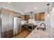 Well-appointed kitchen with stainless steel appliances, wood cabinets, granite countertops, and ample storage space at 1640 Winona Ct, Denver, CO 80204