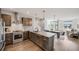 Open-concept kitchen featuring stainless steel appliances, wooden cabinetry, granite counters, and hardwood floors at 1640 Winona Ct, Denver, CO 80204