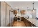 Modern kitchen featuring stainless steel appliances, wooden cabinets, granite countertops, and hardwood floors at 1640 Winona Ct, Denver, CO 80204