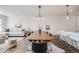 Inviting living space featuring a comfortable sofa, modern décor, hardwood floors, and a seamless transition to the dining area at 1640 Winona Ct, Denver, CO 80204