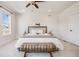 Serene main bedroom with a plush bed, neutral decor, soft carpet, and ample natural light at 1640 Winona Ct, Denver, CO 80204