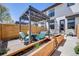 Charming patio area with pergola, outdoor seating, and raised planter boxes for added greenery and privacy at 1640 Winona Ct, Denver, CO 80204