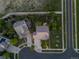 Aerial view of a well-manicured property with mature trees, landscaping, and a spacious driveway on a corner lot at 16815 E Prairie Goat Ave, Parker, CO 80134