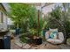 Backyard patio with a swinging chair and landscape lighting creating a relaxing retreat at 16815 E Prairie Goat Ave, Parker, CO 80134
